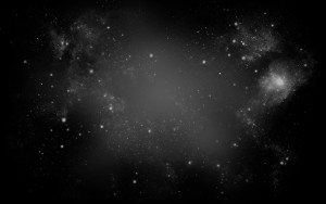 Vast black space with some fog and specks of stars and light.