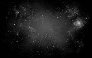Vast black space with some fog and specks of stars and light.